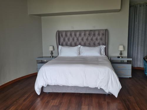 a bedroom with a large bed with white sheets and pillows at Beach House Margate in Margate