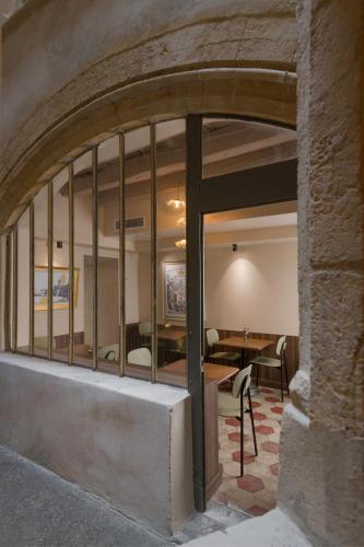 a view of a room with a table and a dining room at Académie Hôtel Lyon in Lyon