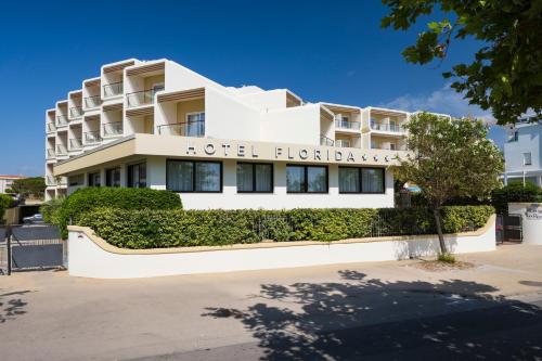 a white building with a sign on it at Hotel Florida in Alghero