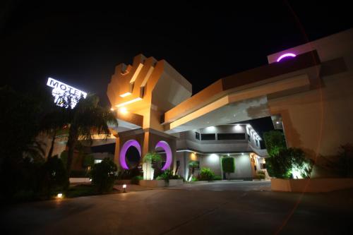 a building with a neon sign in front of it at Motel Mediterraneo in Mexicali
