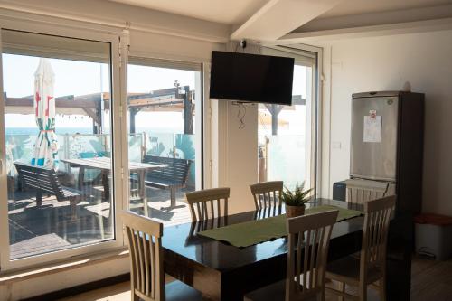 a dining room with a table and a view of the ocean at Wax Suite By the sea in Faro