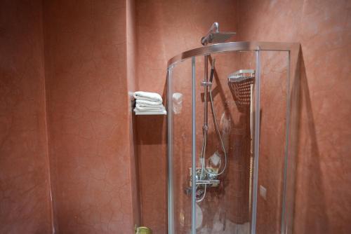 a shower with a glass door in a bathroom at Palais Zahia Hotel & Spa in Tangier
