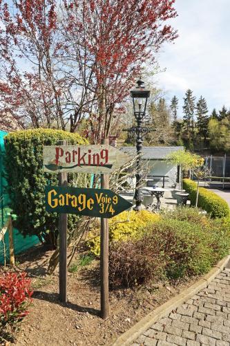 a sign for a park in a garden at Potter's Place by Ardenne Places in Theux
