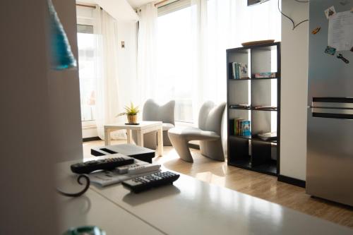 a kitchen with a desk with a keyboard and a calculator at Wax Suite Life is a beach in Faro