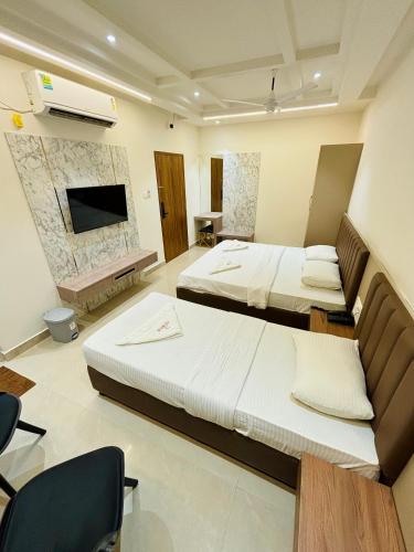 Ένα ή περισσότερα κρεβάτια σε δωμάτιο στο Hotel Citywalk Residency