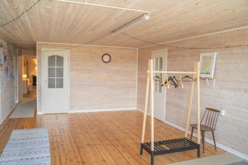 a room with a wall with a clock and a chair at Majutus Massu Ratsaklubis in Massu