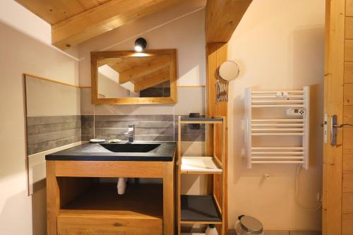 a bathroom with a sink and a mirror at Les flocons in Crest-Voland