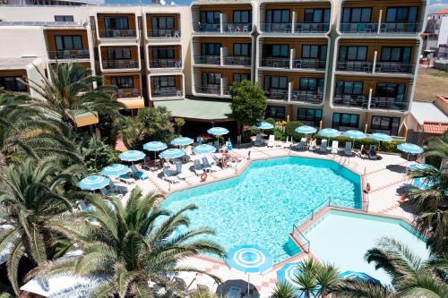 an aerial view of a hotel with a pool and palm trees at Hotel Florida in Alghero