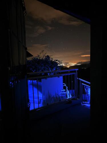 a room with a window with a view of the ocean at night at Wellness pod zvezdami, Maribor - PRIVATE in Maribor