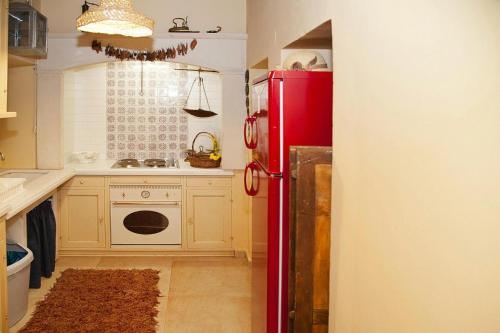 a kitchen with a red refrigerator and a sink at Holiday home in the Archanes with a garden in Archanes