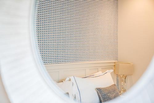 a bedroom with a bed and a mirror at Linhay Cottages 2 in Bathford