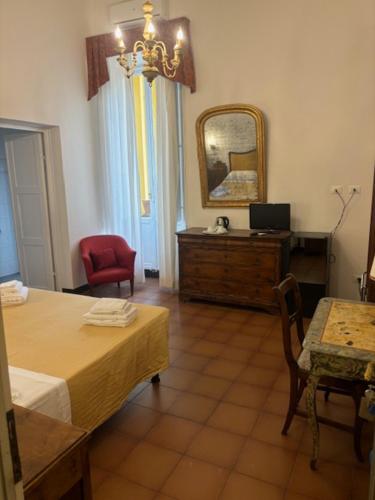 a room with a bedroom with a table and a mirror at Hotel Annalena in Florence