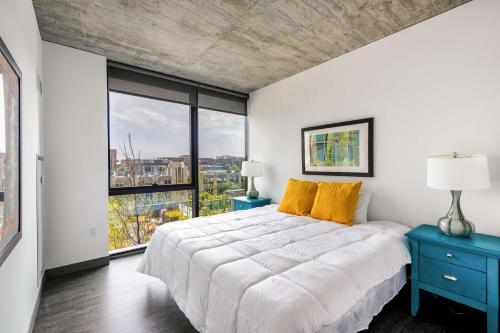 a bedroom with a large bed and a large window at New Sleek 2BR - Perfect Blend of Comfort & Style in Chicago in Chicago