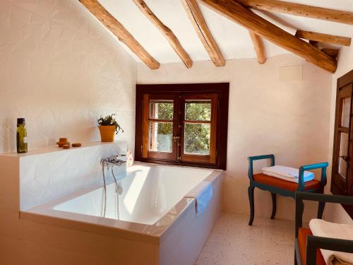 a large white bath tub in a room with a window at CASA DEL AGUA - La Rioja in Santa Coloma