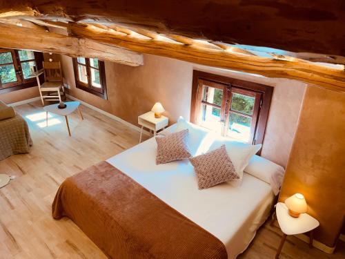a bedroom with a large white bed with two pillows at CASA DEL AGUA - La Rioja in Santa Coloma