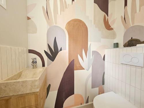 La salle de bains est pourvue d'un lavabo et de toilettes murales. dans l'établissement Maison familiale, 8 couchages, cadre exceptionnel, à Deauville