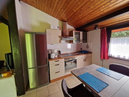a small kitchen with a table and a refrigerator at Holiday Home in Germany with Idyllic Nature in Berneburg