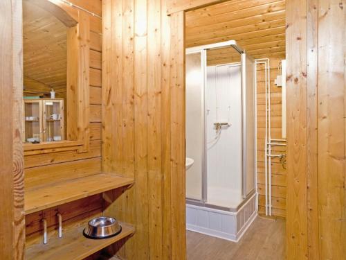 a bathroom with a shower in a wooden wall at Ferienhaus in Hechthausen in Hechthausen