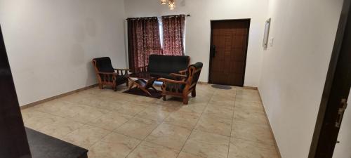 a dining room with two chairs and a table at HillTop in greany meadows yercaud in Yercaud