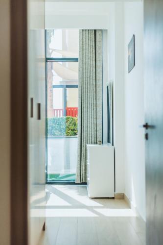a room with a window and a white refrigerator at VESTA - Dubai Residence in Dubai