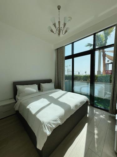 a bedroom with a large bed and a large window at VESTA - Dubai Residence in Dubai