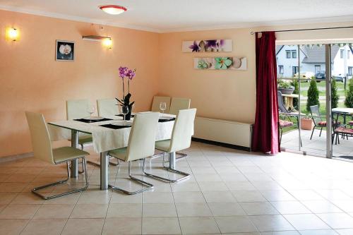 a dining room with a table and chairs at Cottages at the Kummerower See Verchen in Verchen