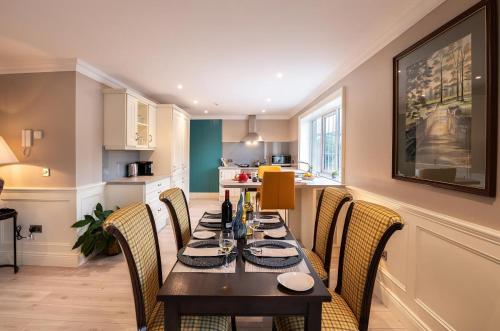 a kitchen and dining room with a table and chairs at Robeen House in Killarney