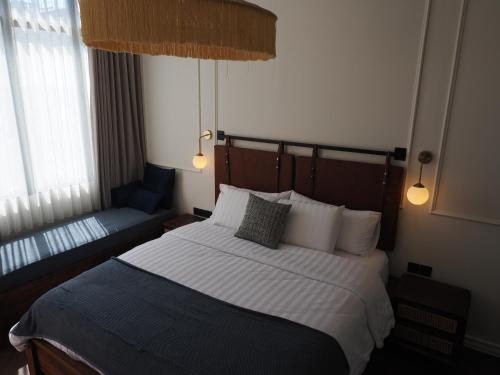 a bedroom with a large bed and a couch at Blue Marlin Dive Boutique Hotel in Kuta Lombok
