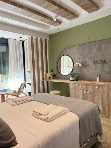 a bedroom with a large bed and a mirror at Leos Apartments Apart2 in Side