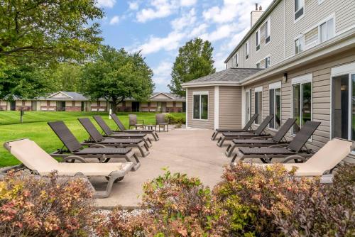 a group of lounge chairs on a patio at Best Western Beacon Inn in Grand Haven