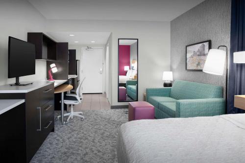 a hotel room with a bed and a desk at Home2 Suites by Hilton Greensboro Airport, NC in Greensboro