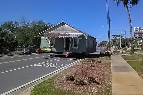 a small house sitting on the side of a road at Diver Down Cottage in Carrabelle