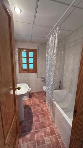 a bathroom with a shower and a sink and a tub at Posada El Rincón de Valverde in Valverde de los Arroyos