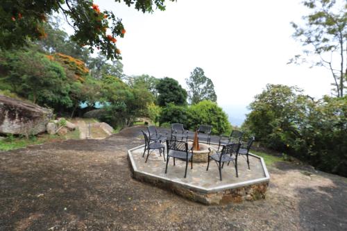 a group of chairs sitting on top of a table at Bawlana Estate - Kandy in Kandy
