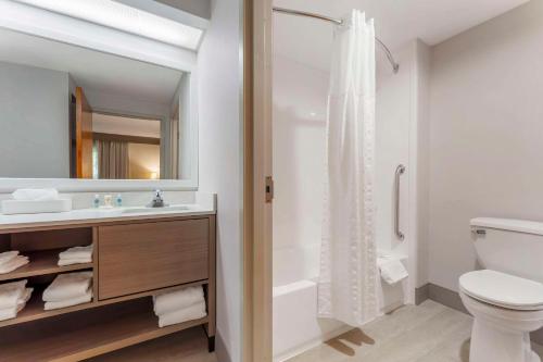 a bathroom with a toilet and a sink and a shower at Comfort Inn & Suites LaVale - Cumberland in La Vale