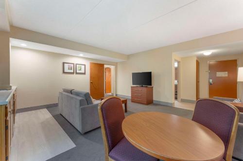 a living room with a table and a couch at Comfort Inn & Suites LaVale - Cumberland in La Vale