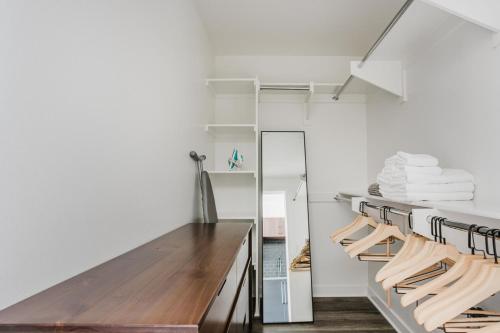 a kitchen with a wooden table and white walls at Blueground Long Beach pool gym near bars LAX-1260 in Los Angeles