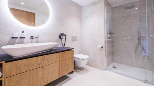 a bathroom with a sink and a toilet and a shower at Vista Apartments in Dolní Morava