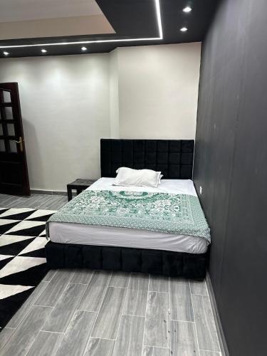 a bedroom with a bed with a black headboard at Relaxing Villa with private pool in King Mariout