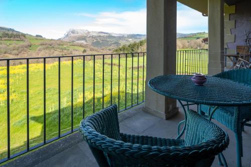 a table and chairs on a balcony with a view at Hotel Alma de Romero in Carranza