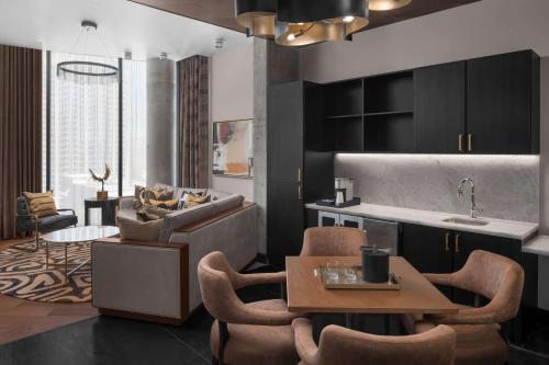 a kitchen and living room with a table and chairs at Hotel Fraye Nashville, Curio Collection By Hilton in Nashville