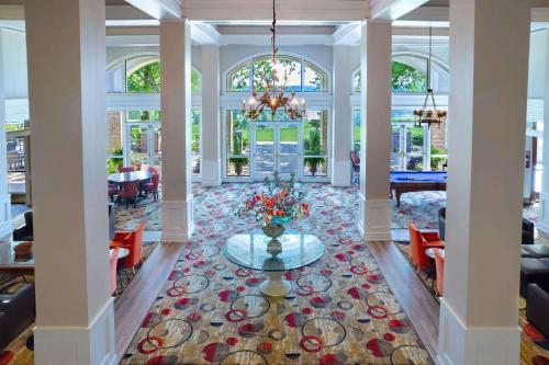 a lobby with a table in the middle of a room at Cypress Bend Resort, a Wyndham Hotel in Many