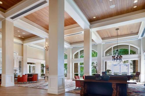 an open lobby with a pool table in the middle at Cypress Bend Resort, a Wyndham Hotel in Many