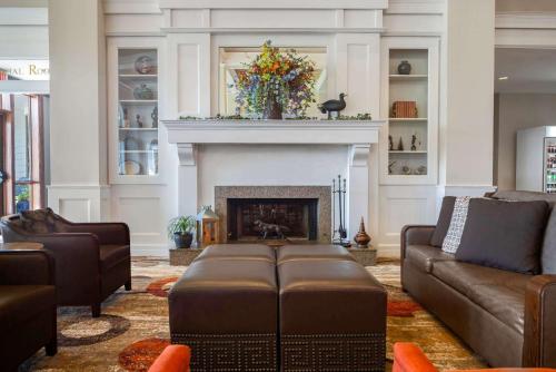 a living room with a couch and a fireplace at Cypress Bend Resort, a Wyndham Hotel in Many