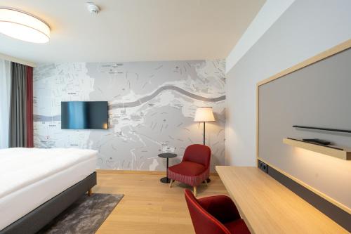Postel nebo postele na pokoji v ubytování IntercityHotel Heidelberg