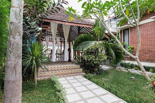 a house with a walkway in front of a building at Villa de Tristan Yogyakarta in Mutihan