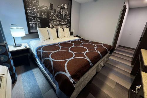 a hotel room with a large bed in it at Super 8 by Wyndham Brooklyn Fulton Street Broadway Junction in Brooklyn