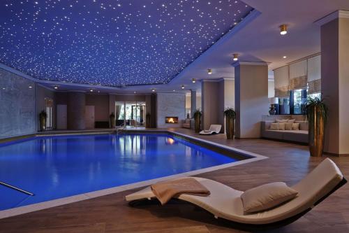 a swimming pool with a star ceiling at Hilton Frankfurt Gravenbruch in Gravenbruch