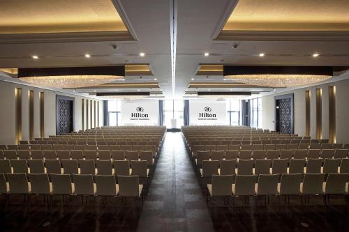 an empty auditorium with rows of chairs in a building at Hilton Frankfurt Gravenbruch in Gravenbruch