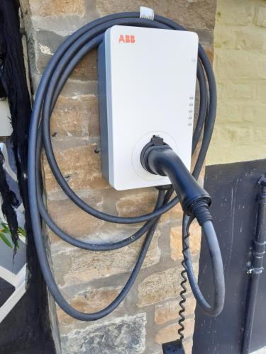 an air conditioner plugged into a wall with a hose at Potter's Place by Ardenne Places in Theux